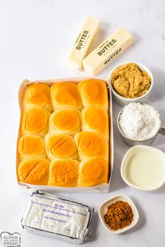 bread rolls in a baking pan with butter, sugar and other ingredients to make them