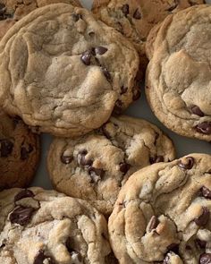 a pile of chocolate chip cookies sitting on top of a table