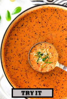 a bowl of tomato basil soup with a spoon in it and the title overlay reads parmesan tomato basil basil soup