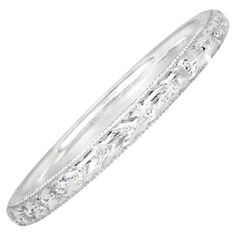 A meticulously handcrafted wedding band draws inspiration from the Art Deco era, boasting intricate hand engravings. Crafted from platinum, the band is adorned with fine milgrain detailing, creating a timeless and elegant piece. Band Width: The band measures 2mm wide, providing a delicate and refined appearance. Ring Size: 6.5 US, Resizable Metal: Platinum Style: Art Deco Width Of Band: 2.00mm Art Deco Era, Hand Engraving, Band Rings, Metallica, Wedding Bands, Platinum, Jewelry Rings, Ring Size, Art Deco