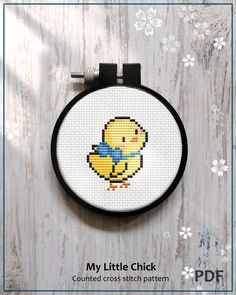 a cross stitch pattern with a little chick on it