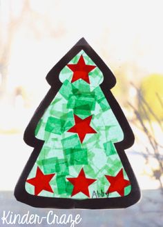 a stained glass christmas tree with red stars