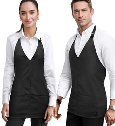 a man and woman in black aprons standing next to each other