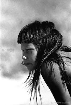 a woman with wet hair standing on the beach