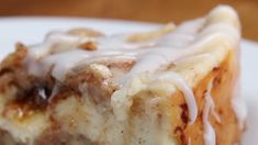 a close up of a piece of cake on a plate with icing drizzled