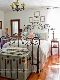 a bedroom with a bed, dresser and mirror