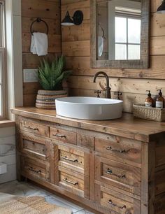 a bathroom with wooden walls and a large white bowl sink on top of the counter