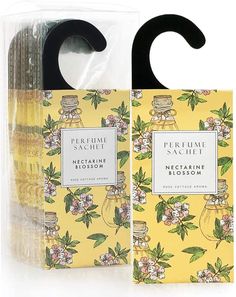 the package contains two bottles of perfume, one in yellow with flowers and leaves on it