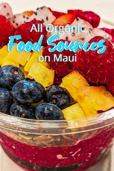 a bowl filled with blueberries, raspberries and oranges