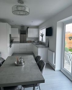 an empty kitchen and dining room are seen in this image