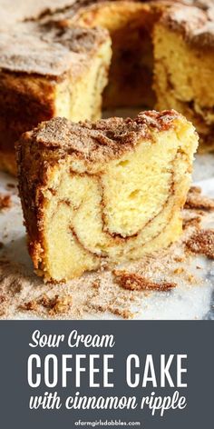 sour cream coffee cake with cinnamon ripples cut in half and served on a plate