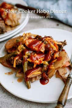 a white plate topped with lots of food next to another plate filled with meat and veggies