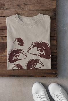 Thanks for stopping by! Grunge Eyes T-shirt Printed on a super soft, cotton tee Dispatched in 5 working days or sooner Unisex Free UK delivery Material: 100% ringspun cotton. Chest (to fit): S  34/36   M  38   L  40/42   XL  44/46   XXL  48/50 ECO-FRIENDLY Each garment is made to order, reducing extra material and energy that would be otherwise wasted We use DTG printing process which is easier on the environment than screen-printing Our ink is bright and also eco-friendly. Do not tumble dry. Wa Emo Cotton T-shirt With Graphic Design, Halloween Grunge T-shirt With Anime Print, Emo Style Cotton T-shirt With Graphic Design, Grunge Shirt With Front Print, Emo Anime Print T-shirt For Halloween, Halloween Anime Print Emo T-shirt, Grunge Anime Print Cotton T-shirt, Halloween Anime Print Cotton T-shirt, Cotton Anime Print T-shirt For Halloween