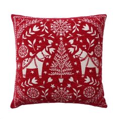 a red and white pillow with an elephant design on the front, surrounded by snowflakes