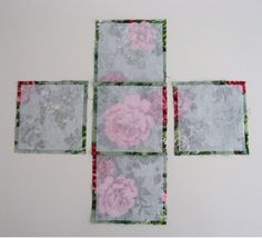 four square pieces of fabric with pink and green flowers on them are arranged in the shape of squares