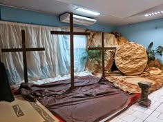 a room filled with lots of fake rocks and crosses on the floor in front of a window