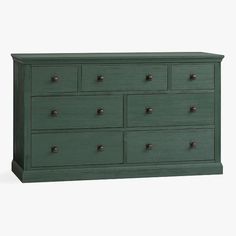 a green dresser with many drawers and knobs on the bottom drawer, in front of a white background