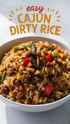 a bowl filled with rice and vegetables on top of a white tablecloth that says easy cajun dirty rice