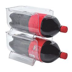 two bottles of red wine are sitting in a plastic holder on a white background, one is empty and the other is half full