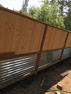 a wooden fence with metal slats on it