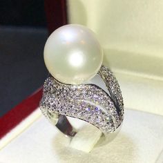 Enormous SOUTH SEA PEARL, absolutely natural color and luster, 14.5 mm in size, surrounded by 257 pieces of hand-set E/VVS superb quality diamonds, weighting at 3.05 carats. Set in handcrafted, one of a kind 18K solid white gold ring, weighting at 13.5 grams. The pearl is naturally cultured from South Australia Sea, its luster is extra fine, AA+ grade with 85% clean surface. SUGGESTED RETAIL PRICE: $13,800 The ring is hand crafted to a high standard and is NOT mass machine produced and is brand Luxury White Diamond Ring For Party, Exquisite White Pearl Ring With Diamond Accents, White Diamond Party Ring, Exquisite White Pearl Ring With Diamond, Exquisite White Diamond Pearl Ring, White Diamond Ring For Party In Fine Jewelry Style, White Diamond Ring For Party, Fine Jewelry, White Diamond Ring For Party, Elegant White Diamond Ring For Party