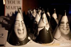 black and white photograph of party hats with photos on them