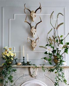 the fireplace is decorated with deer heads and flowers