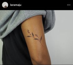 a woman's arm with a tattoo on it that has flowers in the middle