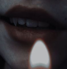 a woman's mouth with light coming out of it