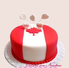 a red and white cake with hearts on top