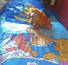 there is a stuffed bear that is laying on the bed with two other teddy bears