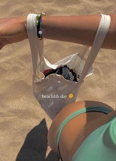 a person holding onto a bag on the beach