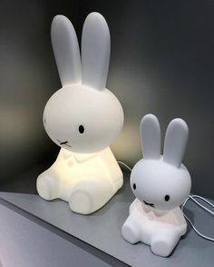 a white rabbit lamp sitting next to a stuffed animal