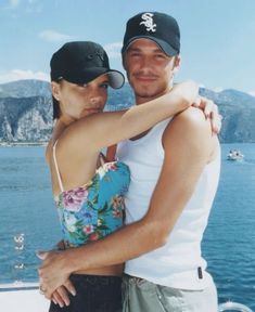 a man and woman embracing each other on a boat