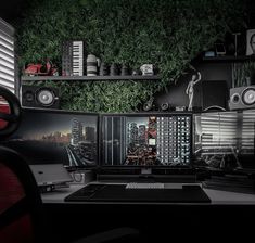 a computer desk topped with two monitors and speakers