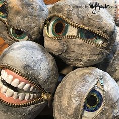 some rocks with eyes and teeth on them