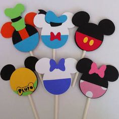 mickey mouse cupcake toppers are arranged on sticks