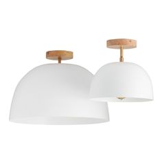 two white lamps hanging from the ceiling with wood accents on each light fixture, and one is