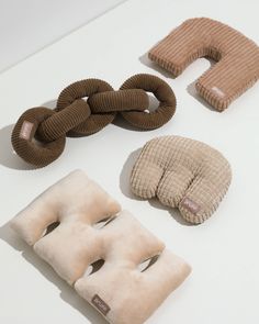 four different types of pillows are arranged on a white counter top, including one for the head and one for the neck