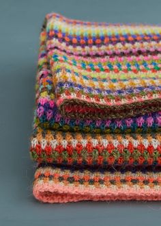 multicolored crocheted blanket folded on top of each other