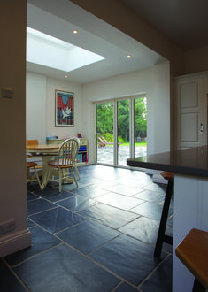 an open kitchen and dining room with sliding glass doors