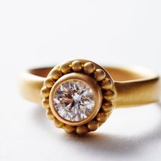 a gold ring with a diamond in the center