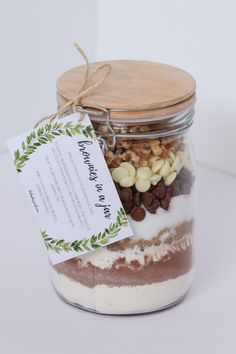 a jar filled with food sitting on top of a white table next to a tag