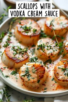 scallops with vodka cream sauce on a plate