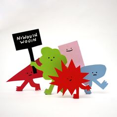 four different colored paper figures holding a sign that says niwounn woon