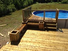 an above ground swimming pool with wooden decking