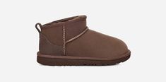 The Classic Ultra Mini features a low shaft height, adding easy on-off and enhanced versatility. Pre-treated to keep it looking better for longer, this Classic features everything kids love about the original: signature sheepskin lining, an ultra-soft UGG®plush insole, and a flexible, ultra-lightweight sole made for all-day play. Pair with our matching adult-sized boot for cute mini-me photo ops.The outsole of this product is either a sugarcane EVA outsole, which is a responsible compound using Ugg Mini Boot, Ultra Mini Ugg, Wishlist Clothes, Ugg Mini Boots, Shoes Wishlist, Ugg Ultra Mini, Boot For Women, Ugg Classic Ultra Mini, Ugg Mini