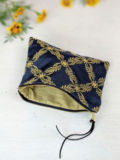 The rich gold and blue brocade fabric on this simple clutch is accented with a shiny brass zipper. The inside of the purse is lined in a regal gold-colored fabric. These purses are a perfect size for everyday essentials. You can fit a cell phone, wallet, lipstick and comb with ease. The sturdy brass zippers make them easy to use. 8.5" X 6" Designer upholstery remnant fabric, fully lined Designed and handmade at the Ash & Rose studio in Massachusetts Limited edition Royal Blue Clutch, Simple Clutch, Blue Clutch, Gold Brocade, Cell Phone Wallet, Royal Blue And Gold, Colored Fabric, Blue Purse, Gold And Blue