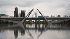 a bridge that is over some water with buildings in the backgrouds behind it