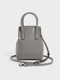 If you are the girl who carries just the essentials, then this Rene top handle in grey is a great alternative to your regular carryall tote bags. Featuring a vertical and structured silhouette, it can actually hold more than you would expect, including a foldable umbrella or a small water bottle. Carry it in hand via the structured top handles or simply clip on the detachable shoulder strap to use it as a crossbody bag. Foldable Umbrella, Small Water Bottle, Structured Top, Carryall Tote, Grey Bag, Charles Keith, Handle Bag, The Girl Who, Clip On